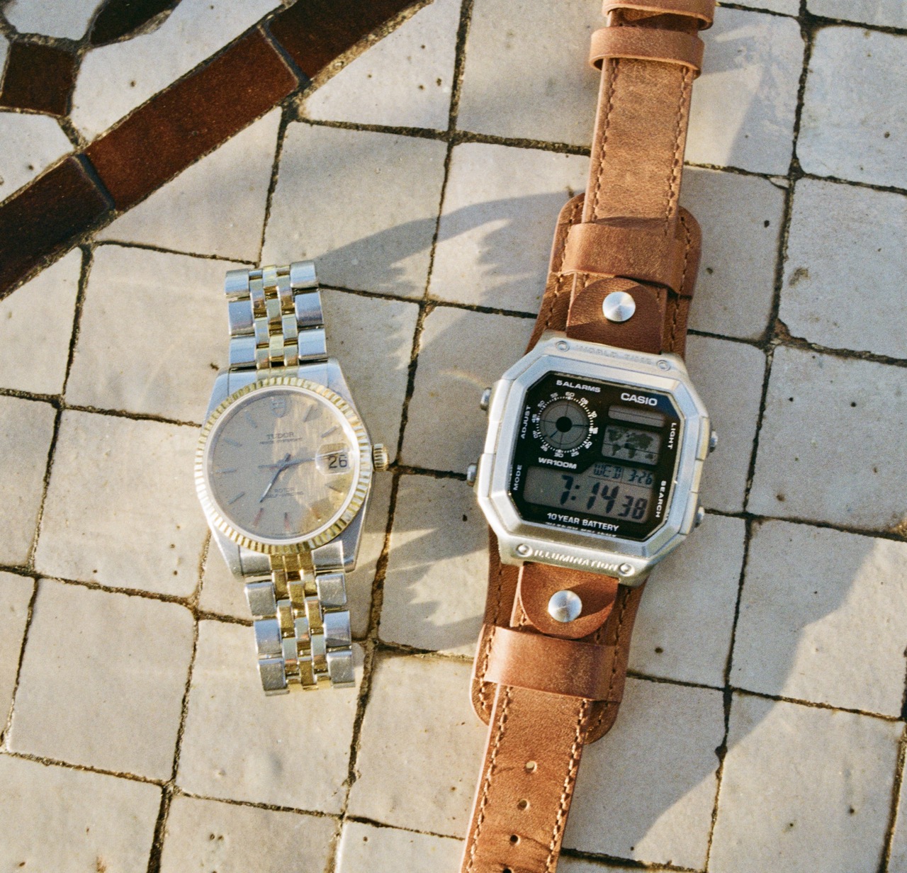 A Casio AE1200 and a Tudor Prince Oysterdate placed on Moroccan tiles